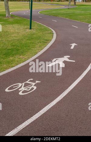 Winding path for pedestrians and cyclists in a park. Stock Photo