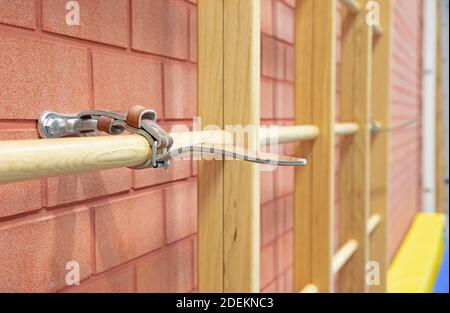 Empty gym in a school with a Swedish wall strapped to the wall Stock Photo