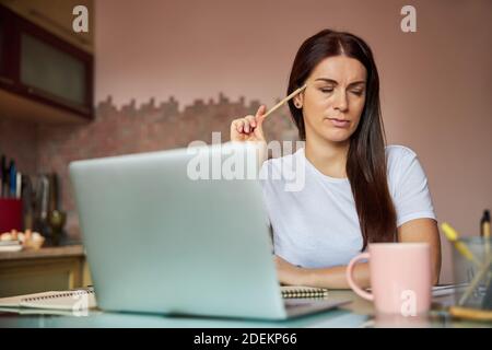 Worker closing her eyes and concentrating on a problem Stock Photo