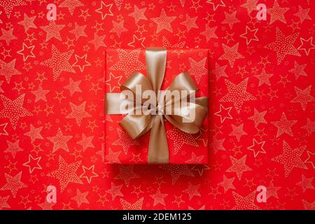 Luxury Christmas gift box wrapped in red paper Stock Photo