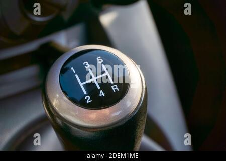 Closeup of manual transmission gear shift on dark background. Stock Photo