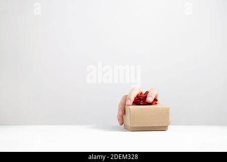 A hand is grabbing a gift from the table nobody Stock Photo