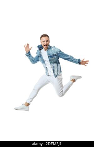 attractive crazy man in denim t-shirt jeans jumping high isolated on white background Stock Photo