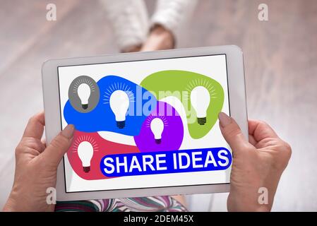 Share ideas concept shown on a tablet held by a woman Stock Photo