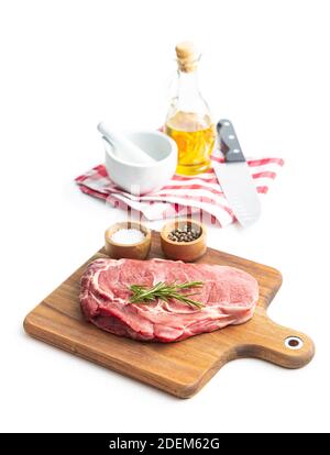 Sliced raw ribeye steak on cutting board isolated on white background. Stock Photo