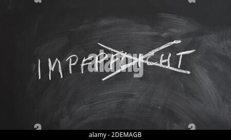 Impfpflicht - compulsory vaccination in German - word crossed out on chalkboard - anti-vaccination concept Stock Photo