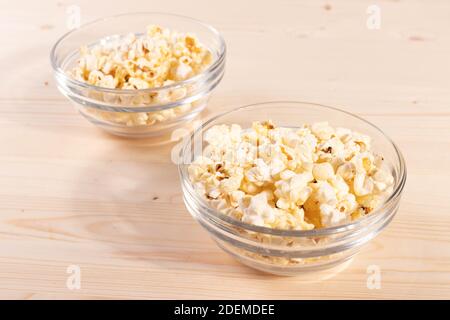 crispy golden ready to eat popcorn in a glass bowl. close up shot. Stock Photo