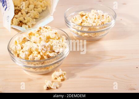 crispy golden ready to eat popcorn in a glass bowl. close up shot. Stock Photo