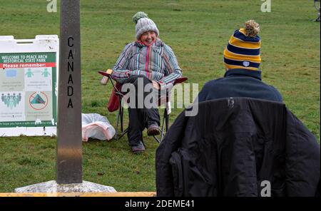 Beijing, Canada-U.S. border. 25th Nov, 2020. People meet at the Peace Arch Historical State Park, where a small portion of it is delineated along the Canada-U.S. border, during the Thanksgiving holiday on Nov. 25, 2020. Credit: Andrew Soong/Xinhua/Alamy Live News Stock Photo