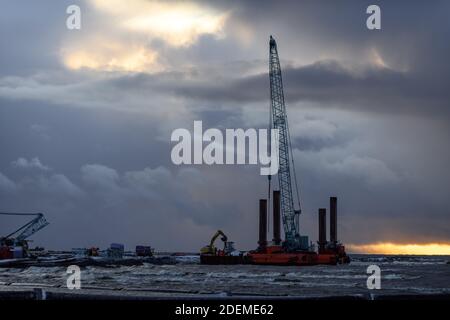 Construction Marine offshore works. Dam building, crane, barge, dredger. Breakwater construction. Stock Photo