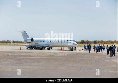 Passengers disembarking from an Air Botswana CemAir Mitsubishi CRJ-100ER jet on arrival on a regional flight, Maun Airport, Botswana, southern Africa Stock Photo