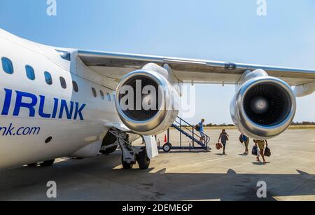 Passengers disembarking from a South African Airlink Avro RJ85 on the runway on arrival on a regional flight, Maun Airport, Botswana, southern Africa Stock Photo