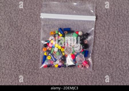 small collection of assorted beads in a small bag from a giveaway promotion Stock Photo