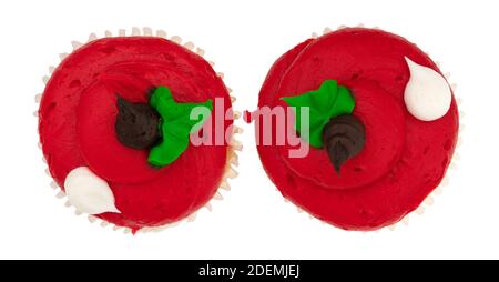 Overhead view of two brightly frosted red cupcakes side by side isolated on a white background. Stock Photo