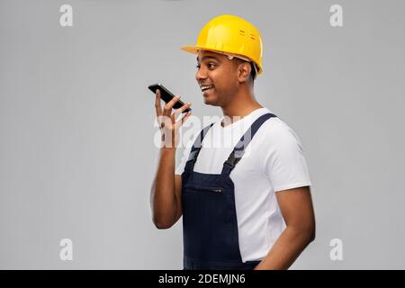 happy indian builder recording voice on smartphone Stock Photo