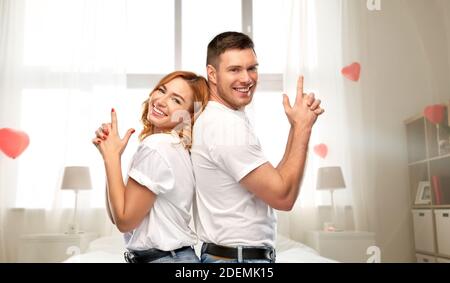 happy couple making gun gesture on valentines day Stock Photo