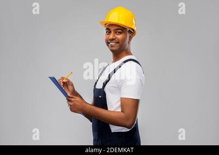 happy builder in helmet with clipboard and pencil Stock Photo