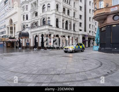 GREAT BRITAIN / England / London /Police patrol Leicester Square . High streets were eerily deserted and footfall plunged 66 per cent on last year. Stock Photo