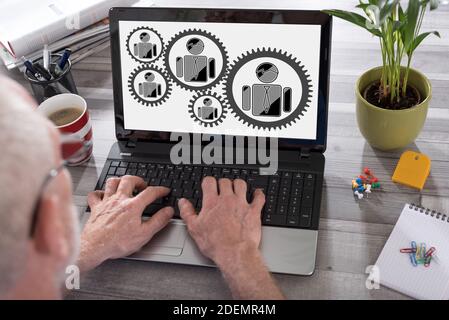 Business team concept shown on a laptop used by a man Stock Photo