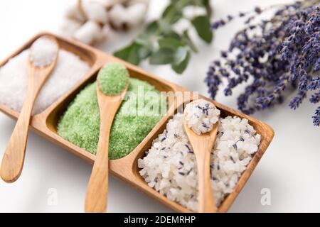 sea salt with wooden spoons and herbs Stock Photo