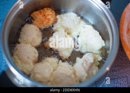 homemade cakes in a pan, fry sweet cheesecakes for tea, boiling oil Stock Photo