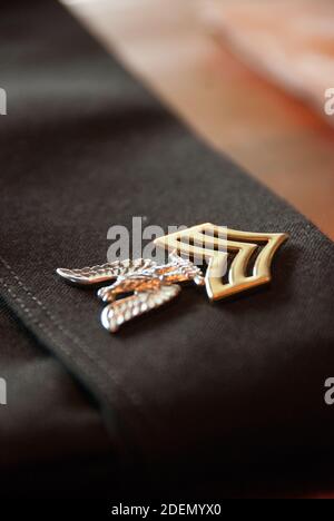 VIRGINIA BEACH, UNITED STATES - May 23, 2012: Close up of a US Navy First Class Petty Officer rank insignia on a black service uniform cover Stock Photo