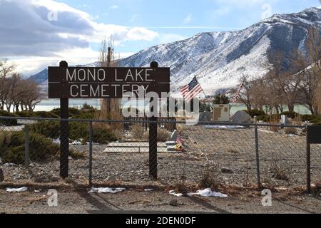 LEE VINING, CALIFORNIA, UNITED STATES - Nov 19, 2020: A wooden sign announces the location of Mono Lake Cemetery in the town of Lee Vining.