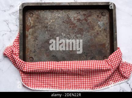 empty rectangular iron baking sheet on white marble table, top view Stock Photo