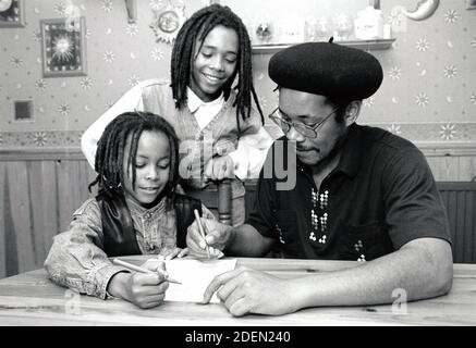 Father helping children with homework / drawing UK 1990s Stock Photo
