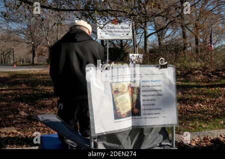 A devout Roman Catholic man prays at the Vatican Pavilion site in Flushing Meadows park where Mary & Jesus appeared to Veronica Lueken. In NYC. Stock Photo