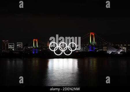 Tokyo, Japan. 1st Dec, 2020. The illuminated Olympic rings, Rainbow Bridge and Tokyo Tower are seen at Tokyo Bay area, in Tokyo, Japan, Dec. 1, 2020. The giant Olympic rings returned to Tokyo Bay here on Tuesday about four months after being removed for safety and maintenance checks. The Rainbow Bridge is specially illuminated in rainbow colors. Credit: Du Xiaoyi/Xinhua/Alamy Live News Stock Photo