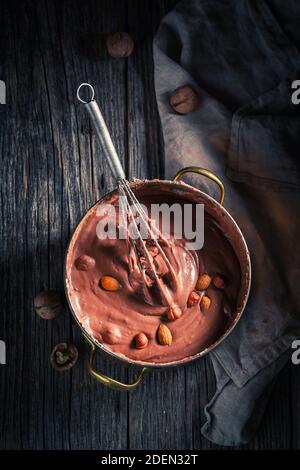 Top view of delicious chocolate made of cocoa and various nuts on old wooden table Stock Photo