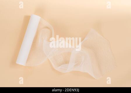 White Bandage isolated on beige background. Stock Photo