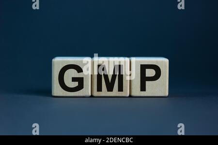 GMP symbol. Concept words 'GMP, good manufacturing practice' on cubes on a beautiful grey background. Business and GMP concept. Copy space. Stock Photo