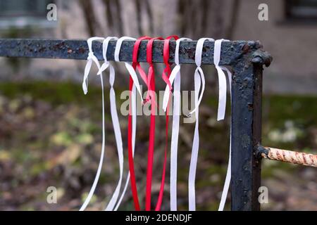 White-red-white ribbons on fence close up, protests in Belarus Stock Photo