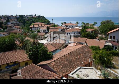 Panoramic view to the old town, houses with orange tile roof. Sea and mountains on the background. Antalya, Turkey. Stock Photo