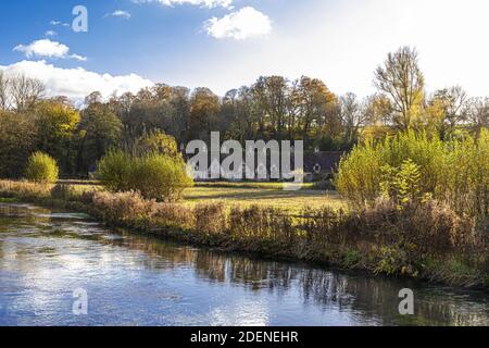 Autumn in the Cotswolds - The River Coln, Rack Isle and Arlington Row in the village of Bibury, Gloucestershire UK