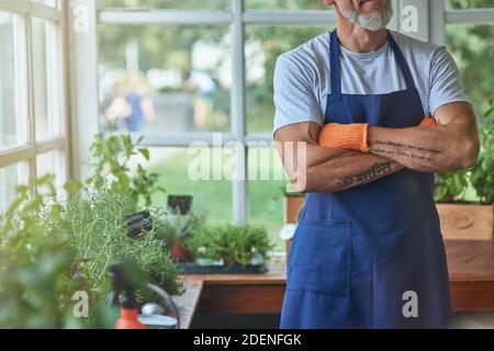 Middle aged caucasian man standing in greenhouse Stock Photo