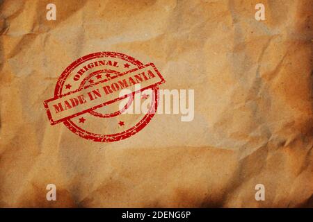 Made in ROMANIA stamp printed on crumpled sheet of burnt paper. Romanian Product Business, parcel, package, production logistics concept. Background w Stock Photo