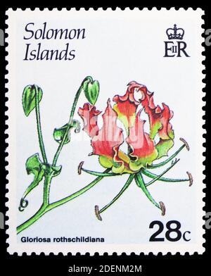 MOSCOW, RUSSIA - JUNE 28, 2020: Postage stamp printed in Solomon Islands shows Gloriosa rothschildiana, Flowering plants serie, circa 1987 Stock Photo