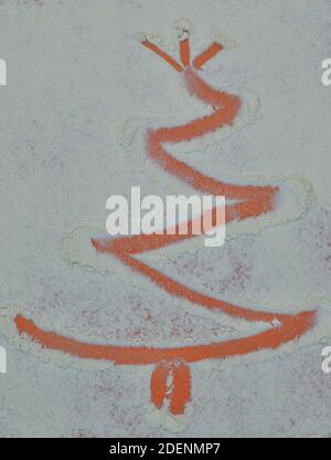 Christmas tree on flour background. White flour looks like snow. Top view Stock Photo