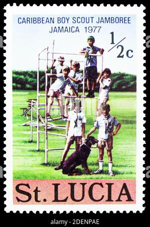 MOSCOW, RUSSIA - JUNE 28, 2020: Postage stamp printed in Saint Lucia shows Children and dog, Carribean Boy Scout Jamborée - Jamaica 1977 serie, circa Stock Photo
