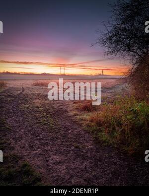 Morning frosty grass on foreground in the morning sunrise autumnal landscape Stock Photo