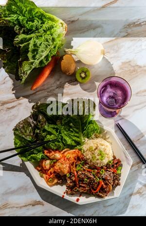 Korean beef bulgogi ssambap lettuce wraps with spicy kimchi and gochujang hot sauce Stock Photo