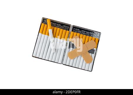 xa cigarette Pack of cigarettes with bandage creating an X a metaphor for the dangers of smoking isolated on white Stock Photo Burning Love Tin Cig Case