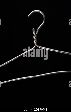 simple metal hanger on a black background Stock Photo
