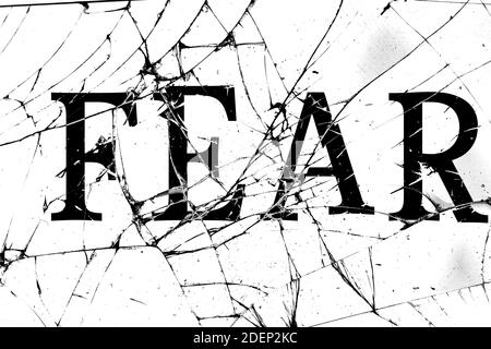 broken glass with cracks with the inscription fear Stock Photo