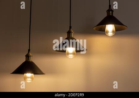 Three lamps with vintage incandescent bulbs with warm light Stock Photo