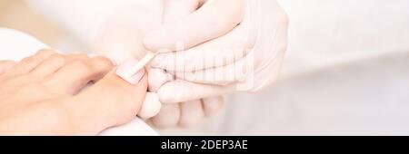 Classic pink wedding toe nail manicure on white backdrop. Spa treatment concept Stock Photo