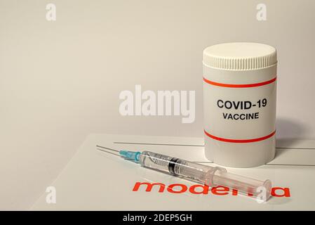 Moderna coronavirus vaccine with a syringe and the company logo on a white background, Denmark, December 1, 2020 Stock Photo